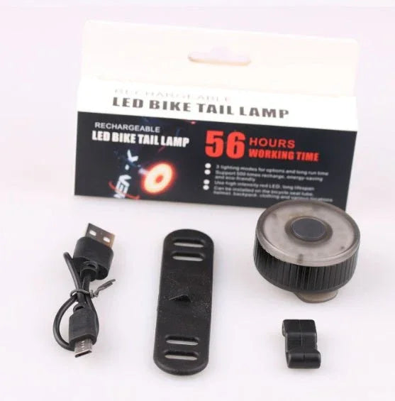 Rechargeable LED bike tail light with USB cable, silicone mounting strap, and long battery life, cycling safety accessory.